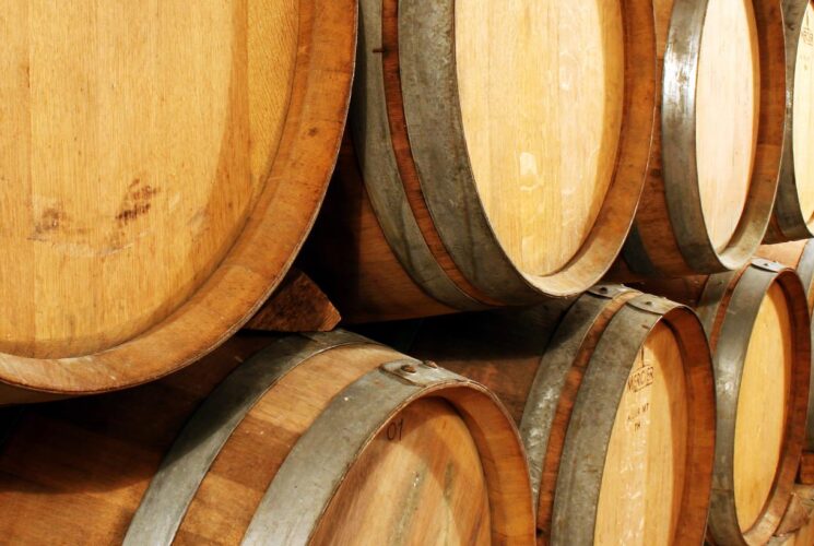 Close up view of stacked oak barrels aging spirits